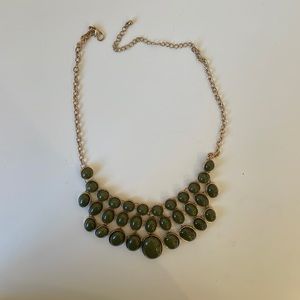 Olive green statement necklace set in gold with gold chain.